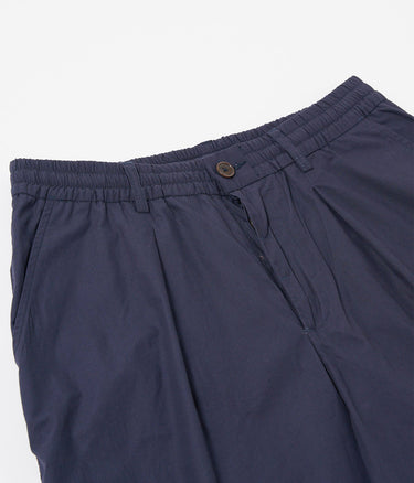 UNIVERSAL WORKS PLEATED TRACK SHORT 34151 PEACHED POPLIN NAVY - Shoelosophy