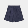 UNIVERSAL WORKS PLEATED TRACK SHORT 34151 PEACHED POPLIN NAVY - Shoelosophy