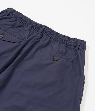 UNIVERSAL WORKS PLEATED TRACK SHORT 34151 PEACHED POPLIN NAVY - Shoelosophy